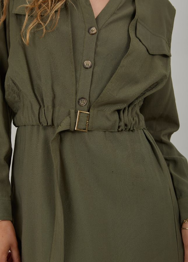 Hoe leuk is deze lange groen utility jurk van Coster Copenhagen. De khaki jurk heeft een V-hals, lange mouwen met schouderdetails, knopen aan de voorkant, twee borstzakken en steekzakken. Door de verstelbare riem in de taille kun je de jurk mooi tailleren. Shop de nieuwe collectie jurken online bij Boetiek Aniek. 